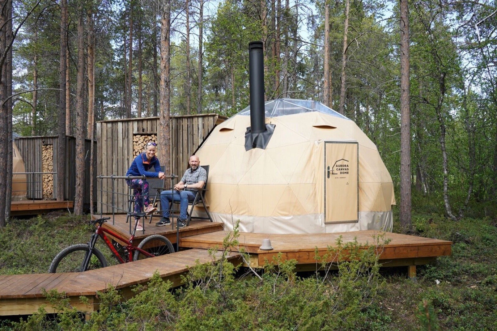An Aurora Canvas Dome among pine trees