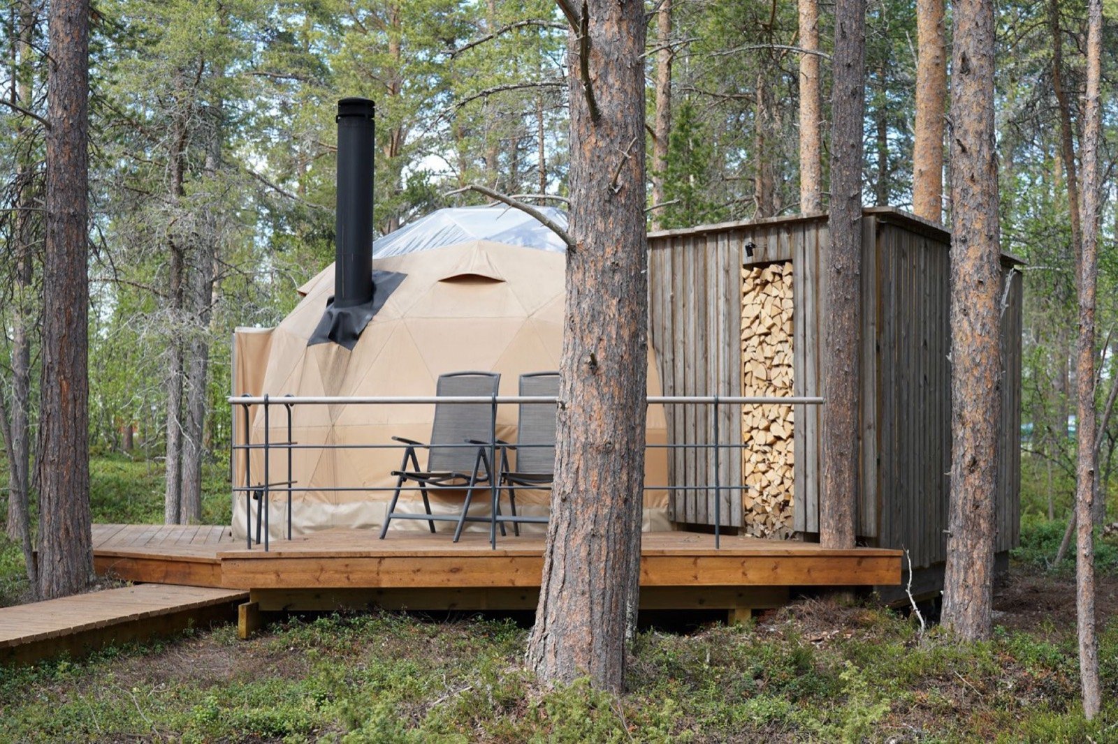 Two Aurora Canvas Domes on wooden decks in the pine forest