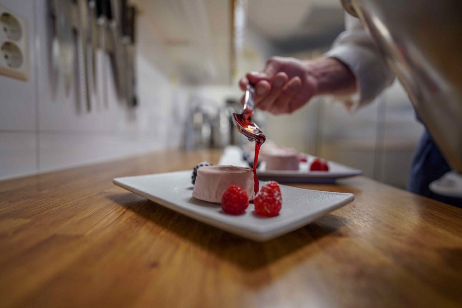 A chef plating a dessert